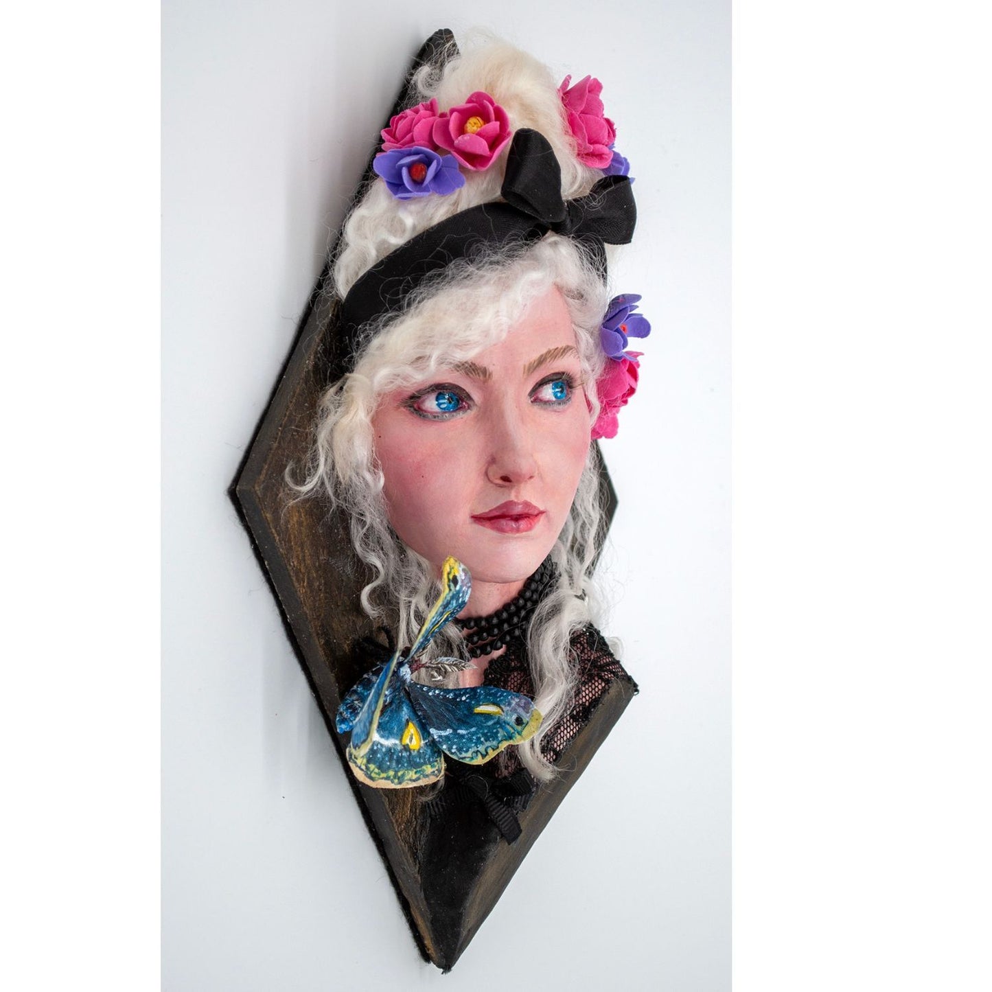 Airdry clay and mixed media sculpture of a woman with a moth