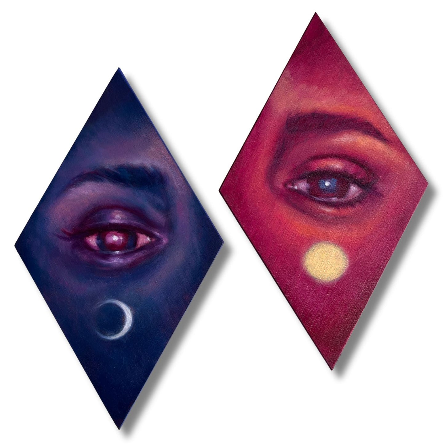 Two diamond-shaped paintings of eyes with contrasting colouring - dusk & dawn.