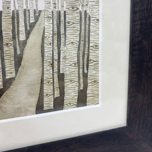 Framed artwork of a forest fill of trees watching the viewer