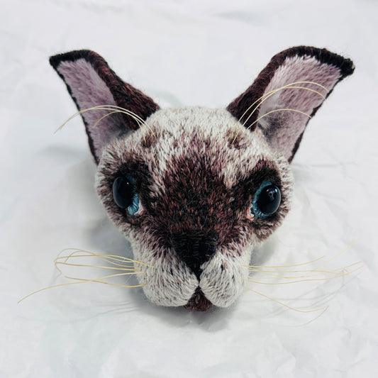 Hand embroidered and felt Siamese kitten mask by Jane Siddall with chocolate point markings