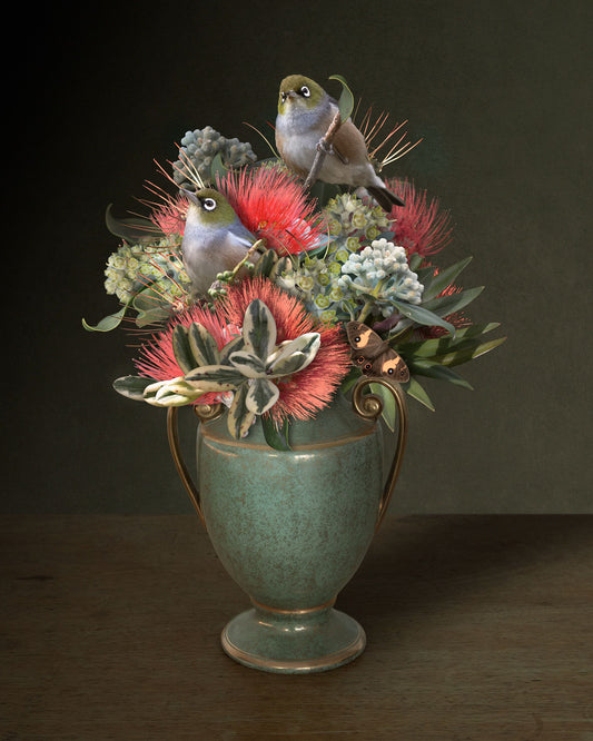 Photographic print featuring a decorative vase with pohutukawa choppings and silvereyes
