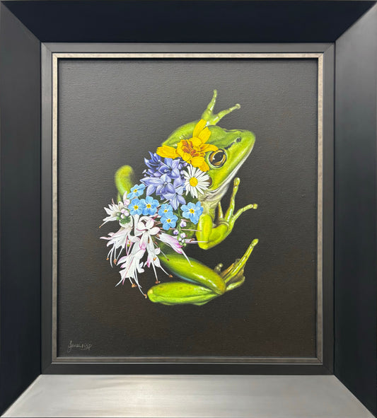 Framed artwork of a green frog with flowers on a gray background