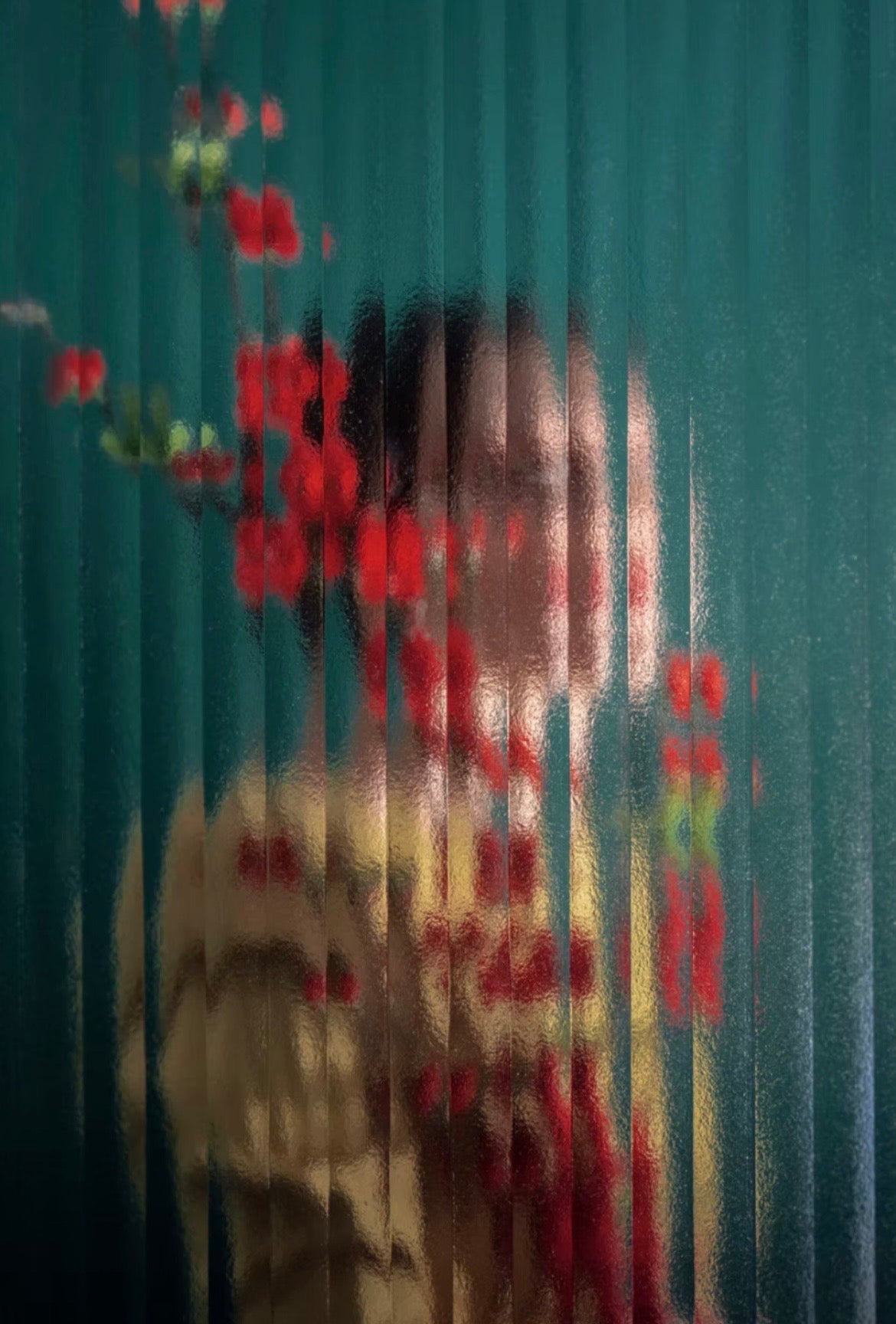 Limited edition photographic print of a women behind glass with red flowers