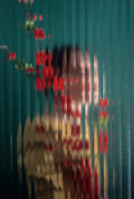 Limited edition photographic print of a women behind glass with red flowers