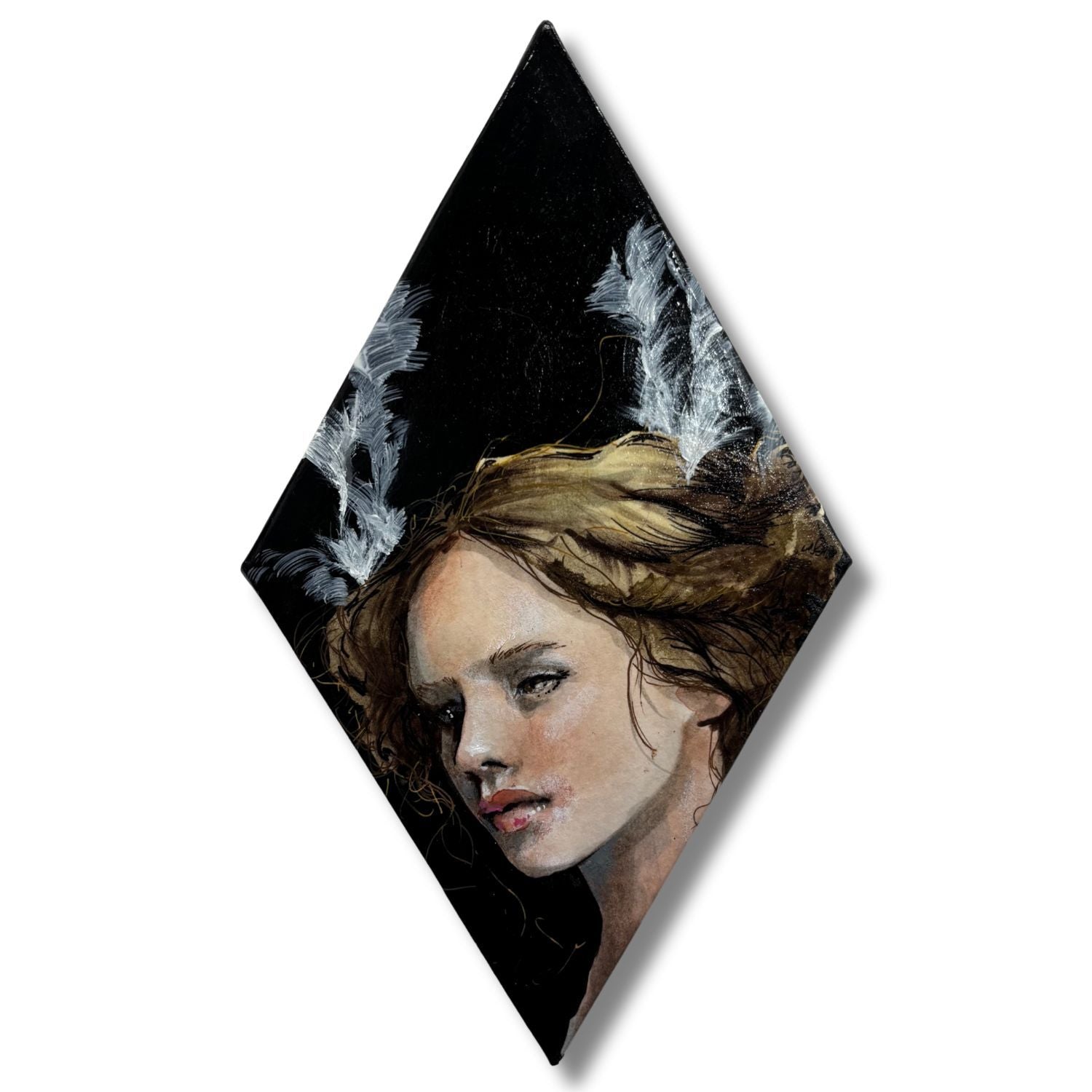 Diamond-shaped artwork of a woman's face with angelic wings on a black background