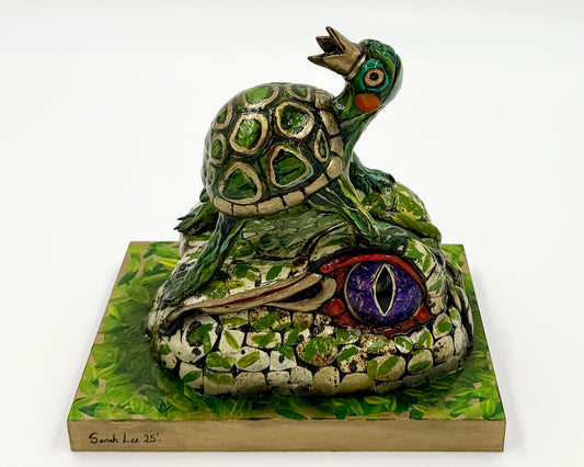 Ceramic turtle sculpture on a square base