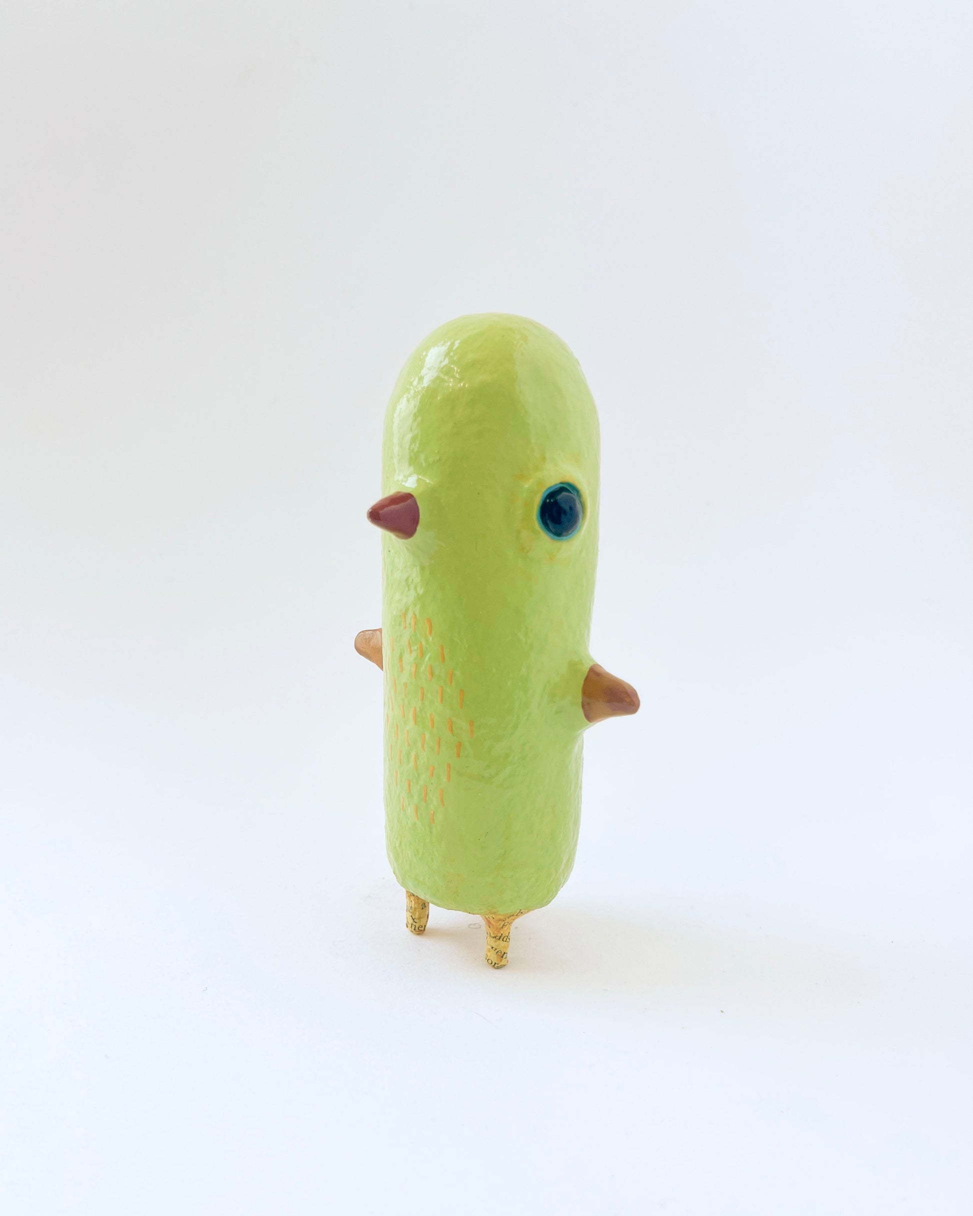 Greenish-yellow paper mache bird like creature