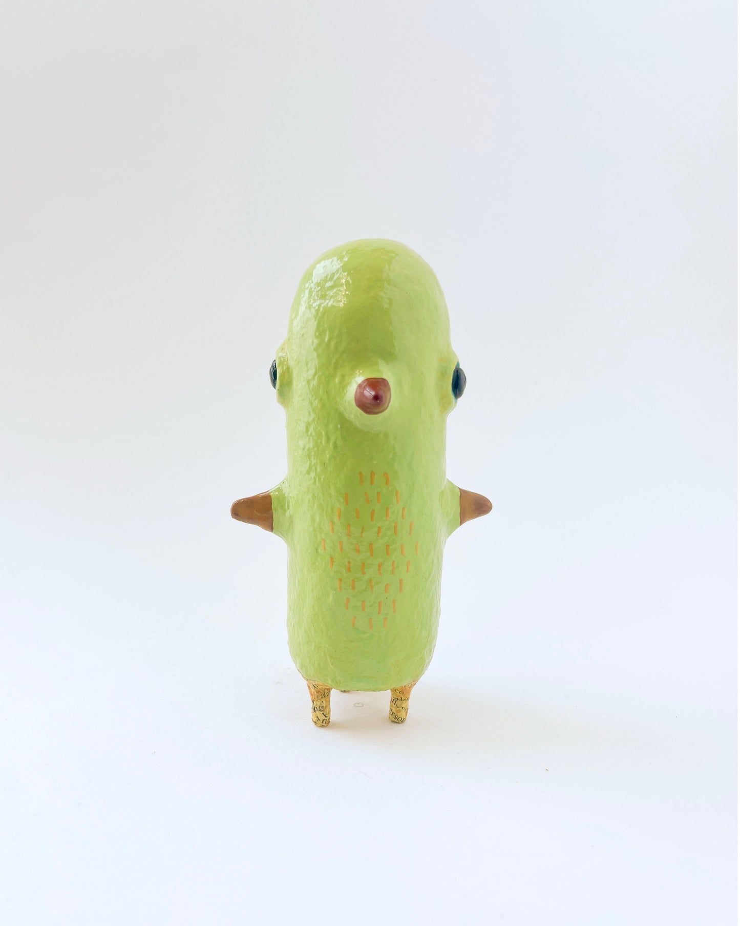 Greenish-yellow paper mache bird like creature