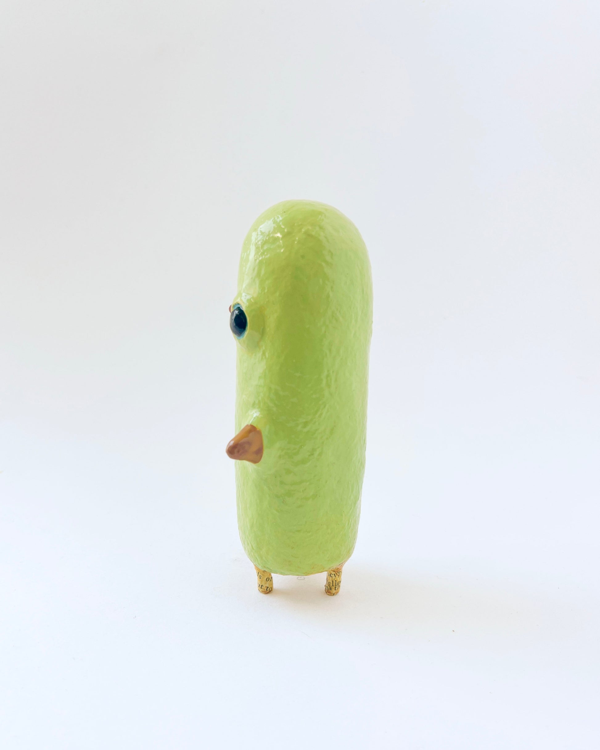 Greenish-yellow paper mache bird like creature