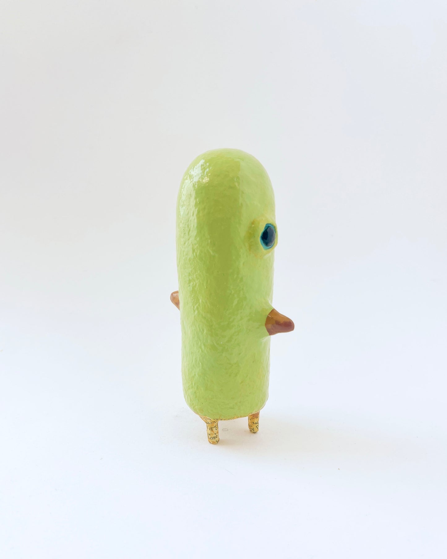 Greenish-yellow paper mache bird like creature