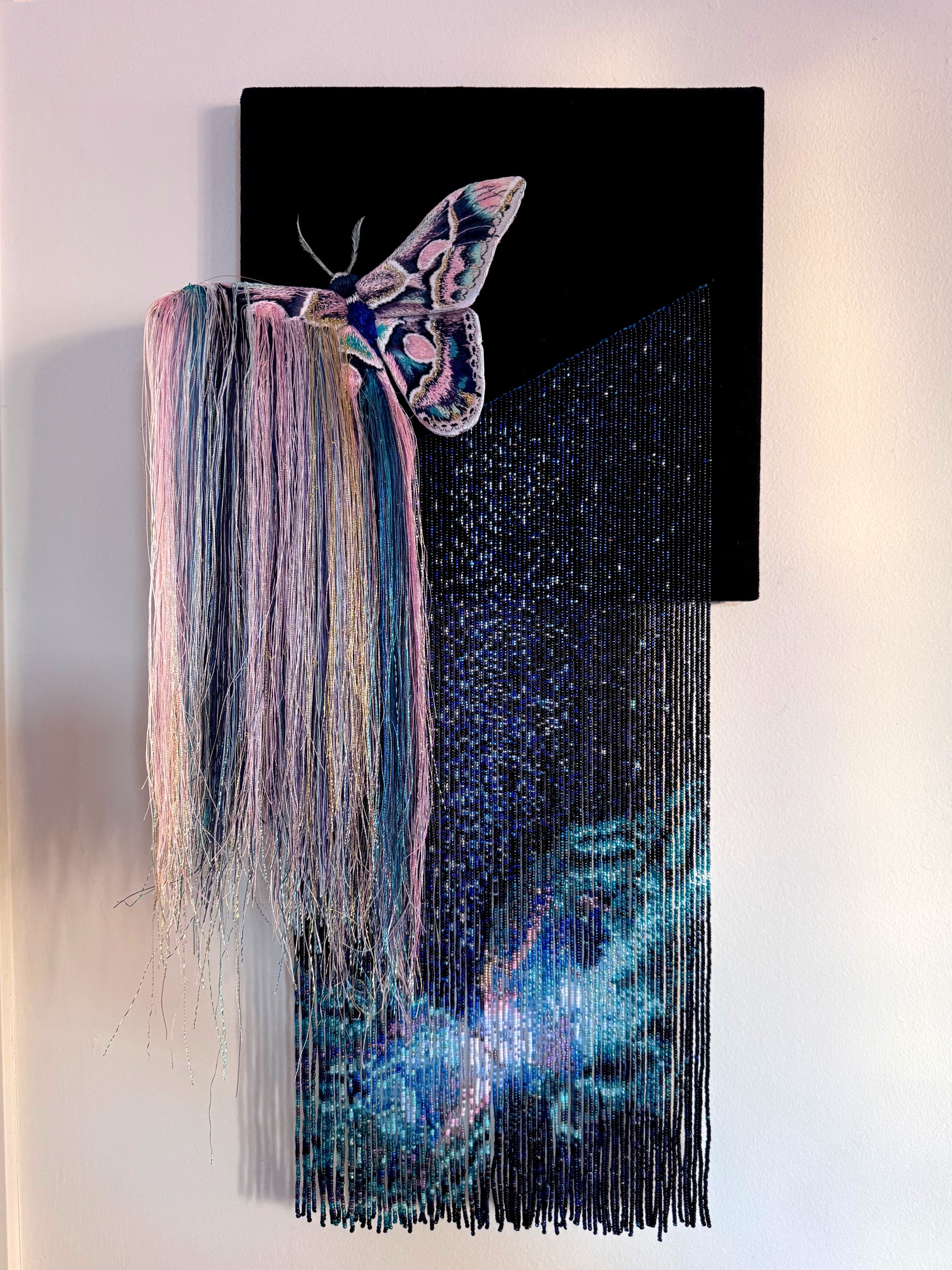 Decorative mixed media wall art with a butterfly and nebula exploding