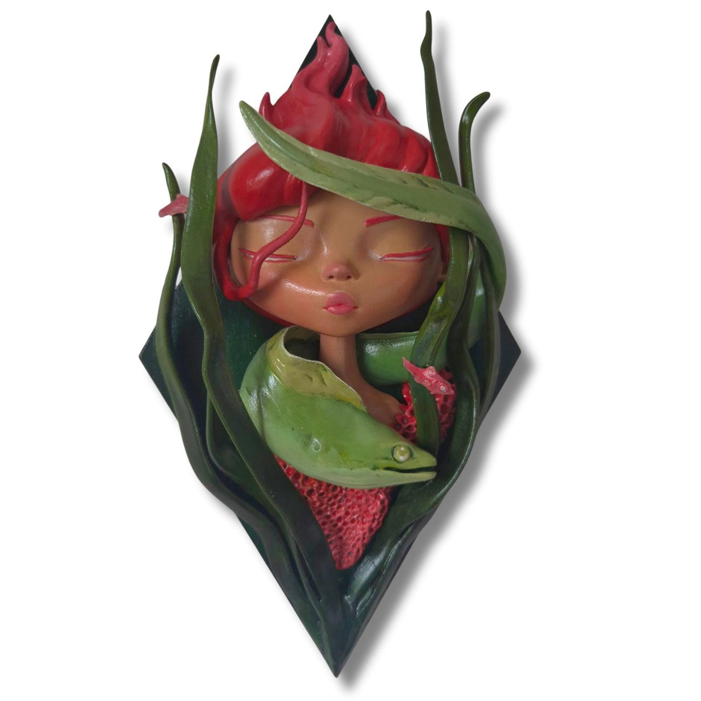 Decorative wall piece with a stylized face surrounded kelp and a sea eel