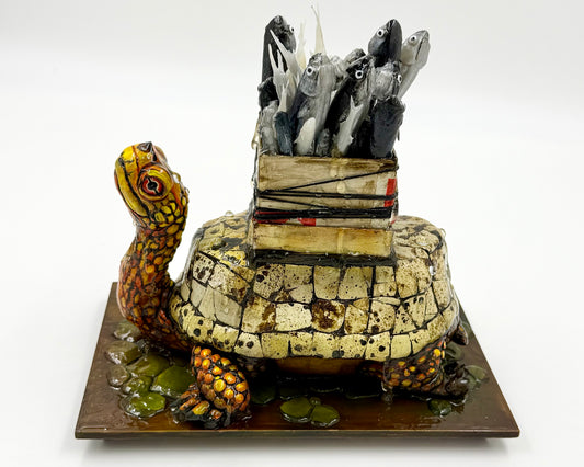 Tortoise sculpture with a box of fish on its back