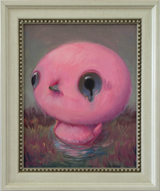 Framed painting of a pink duck with large crying eyes in nature.