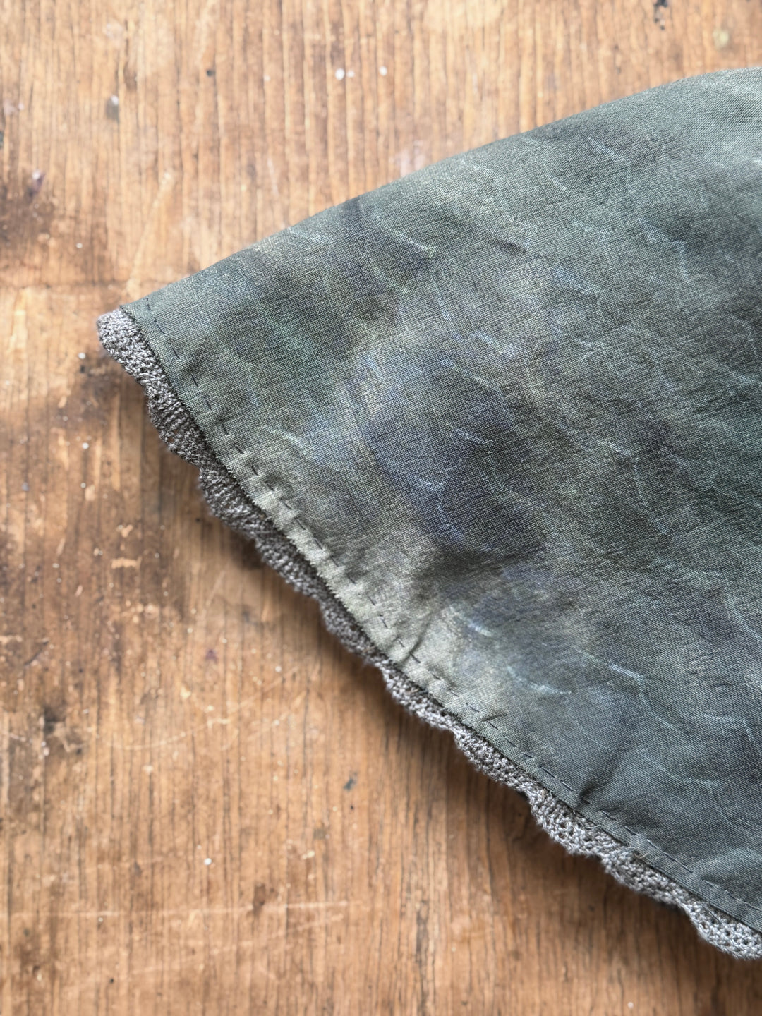 A close-up of the dark gray-green fabric dress/tail of Anne Breymann’s seal