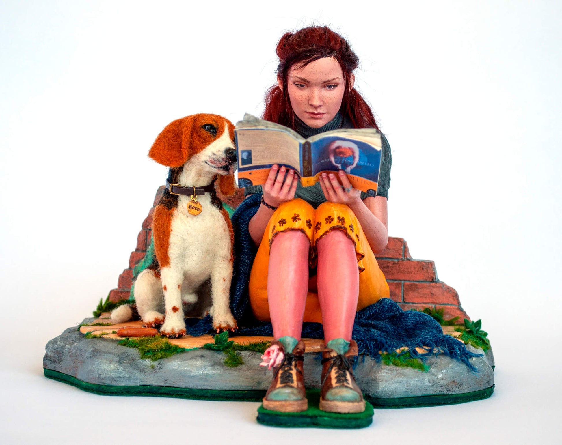 Sculpture of a young woman with a dog reading a book