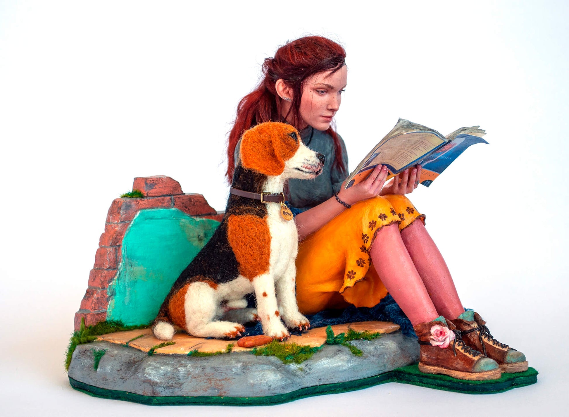 Sculpture of a young woman with a dog reading a book