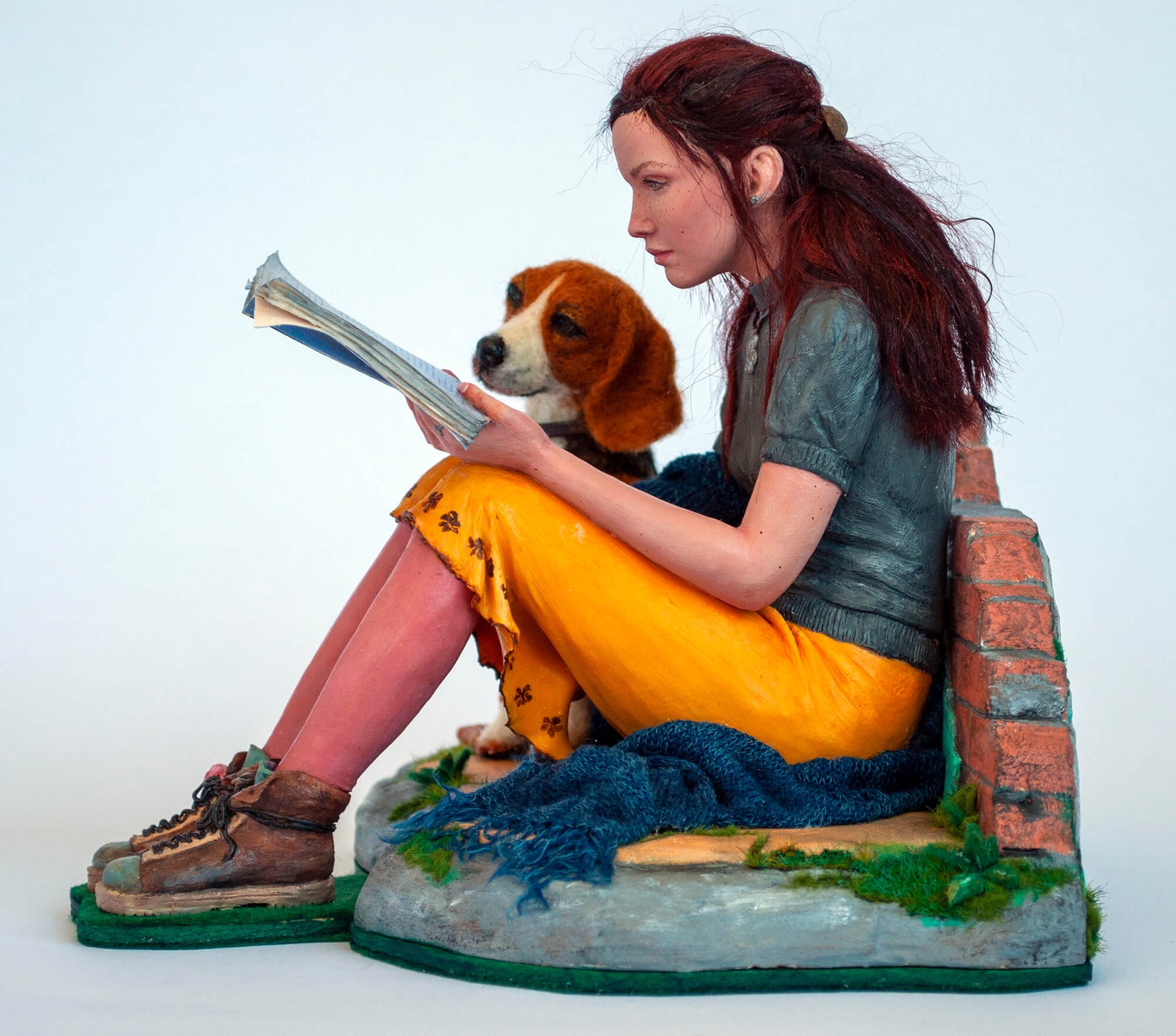 Sculpture of a young woman with a dog reading a book