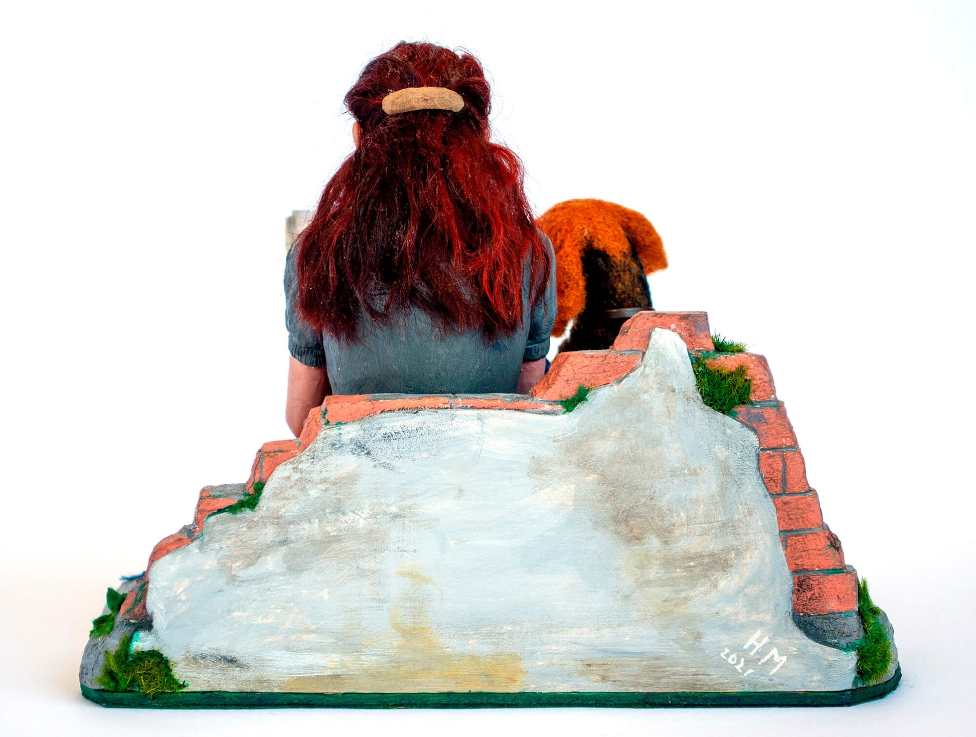 Sculpture of a young woman with a dog reading a book
