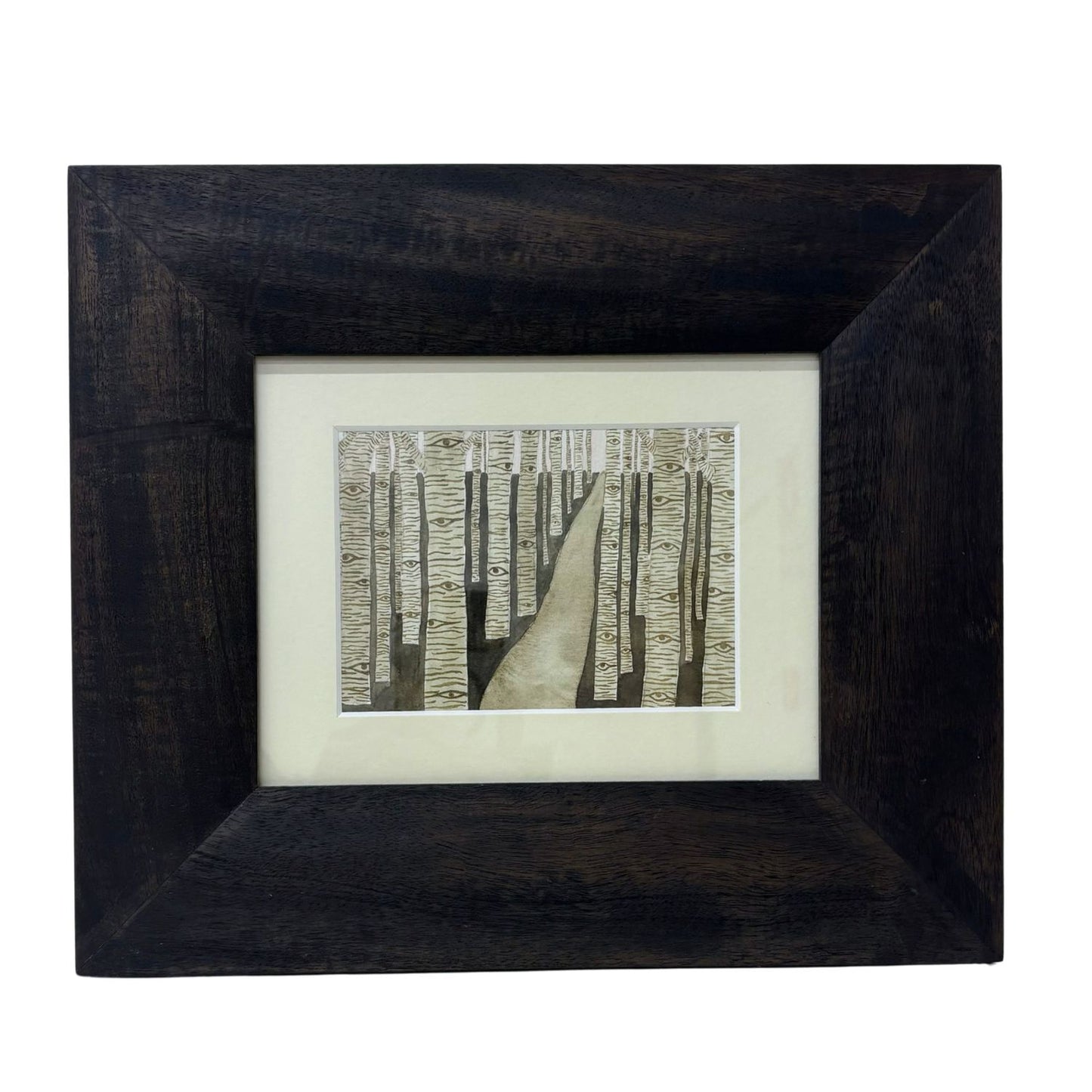 Framed artwork of a forest fill of trees watching the viewer
