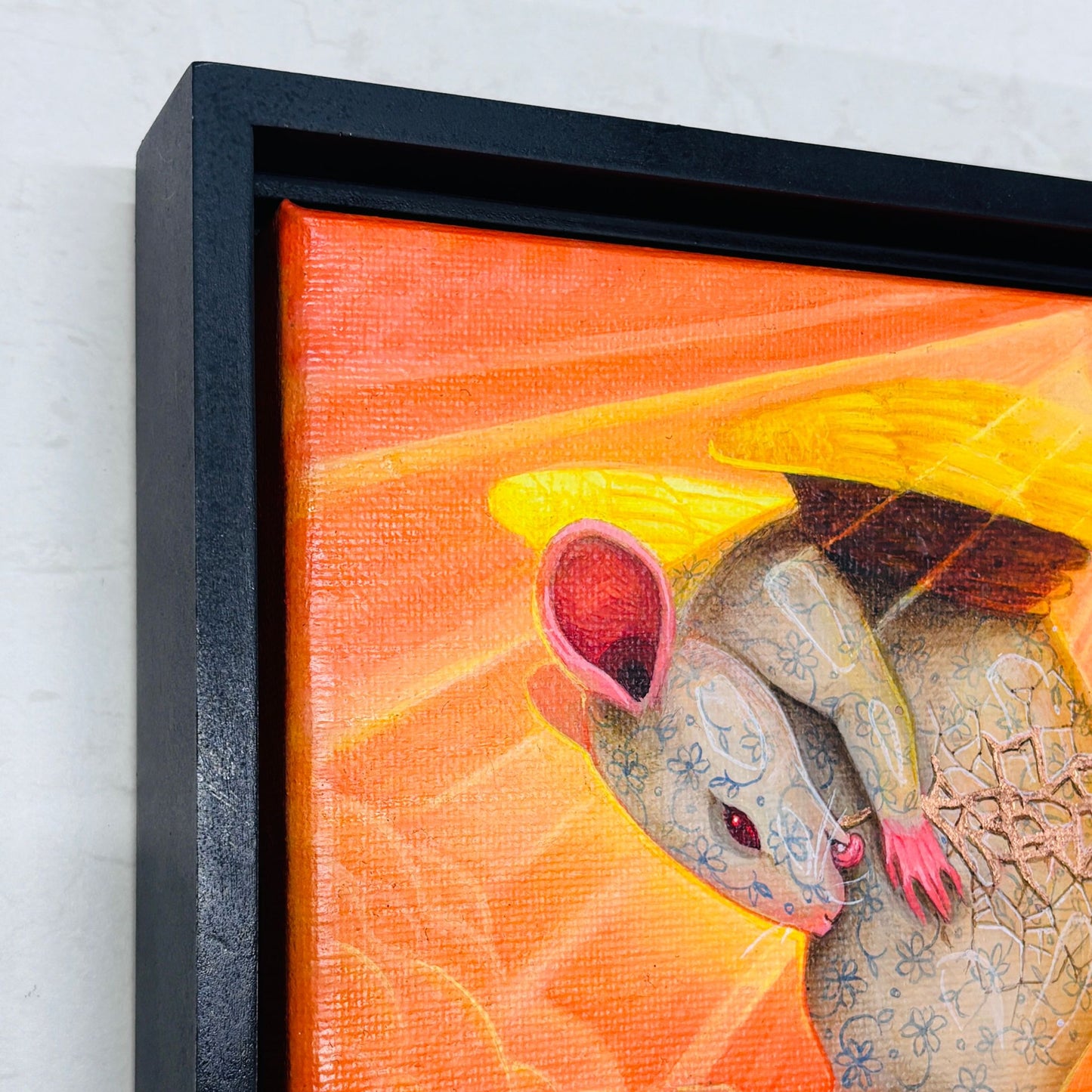 Close up showcasing the copper detailing on Erin Chance’s painting of a winged mouse cleaning itself