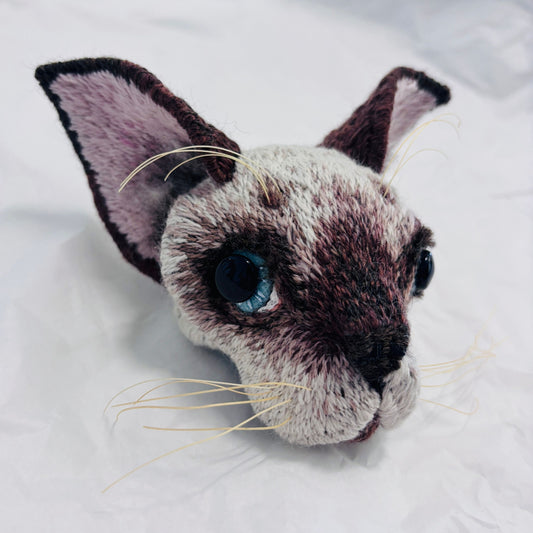 Hand embroidered Siamese kitten mask by Jane Siddall with chocolate point markings