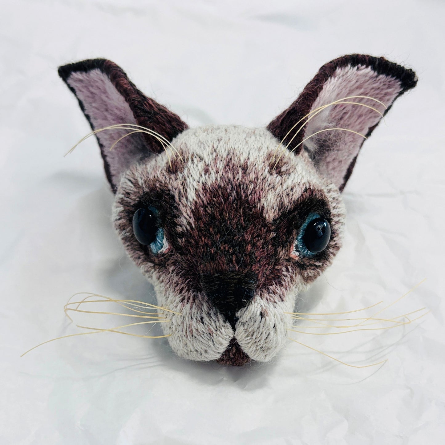 Hand embroidered and felt Siamese kitten mask by Jane Siddall with chocolate point markings